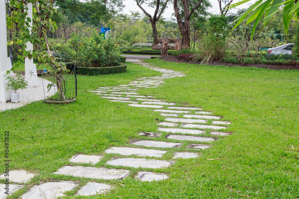Stone walkway pattern on a grassy field perspective
