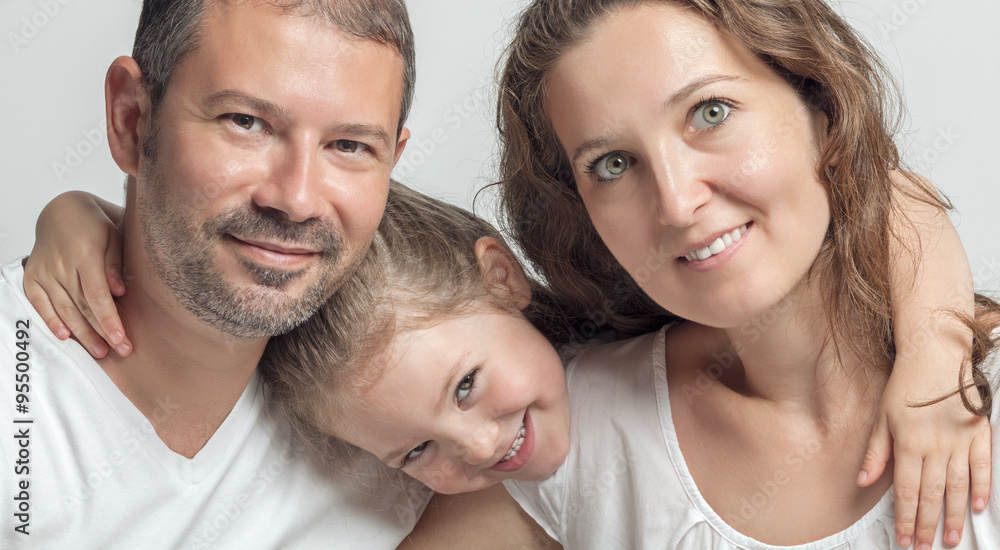 portrait of happy family. Beautiful cute little daughter and her parents. portrait of happy family. Beautiful cute little daughter and her parents.