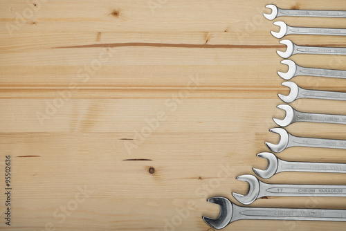 Set of wrenches. Wrenches of several sizes on a wooden background.