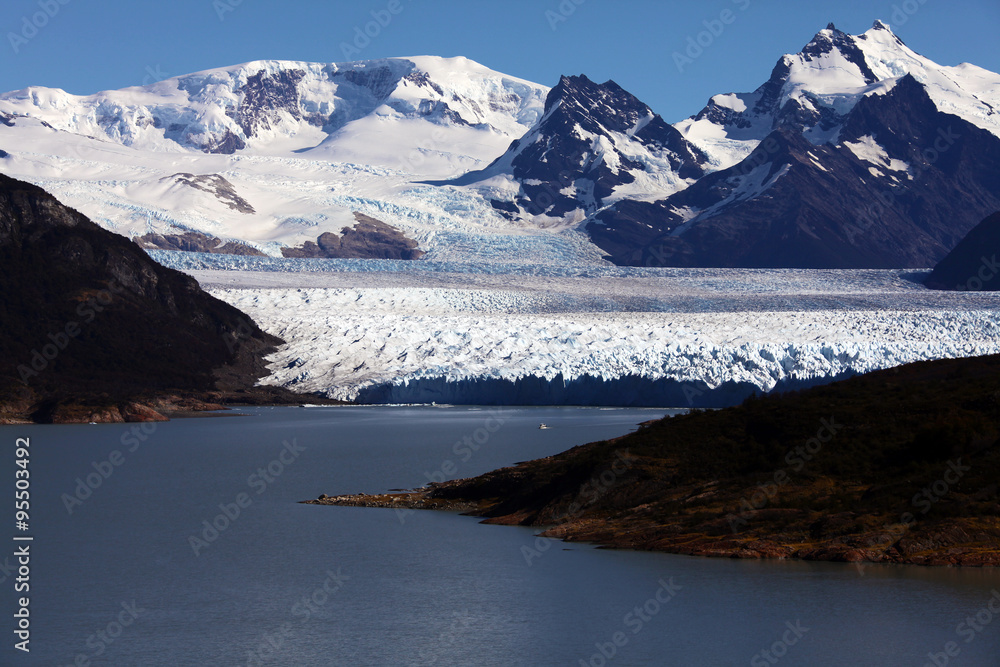 Boat in the distance sailing near Perito Moreno glacier, Patagonia, Argentina