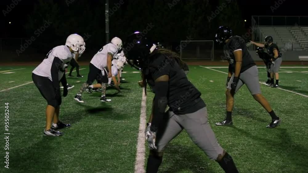 A football player catches a pass and then gets tackled to the ground
A football player catches a pass and then gets tackled to the ground