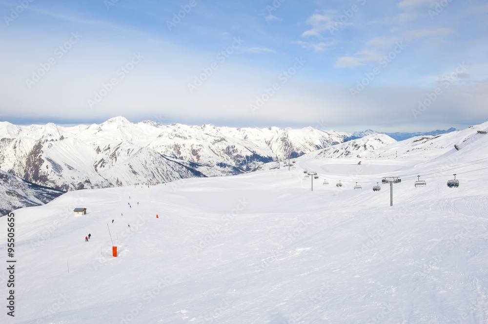 View down a snowy ski piste