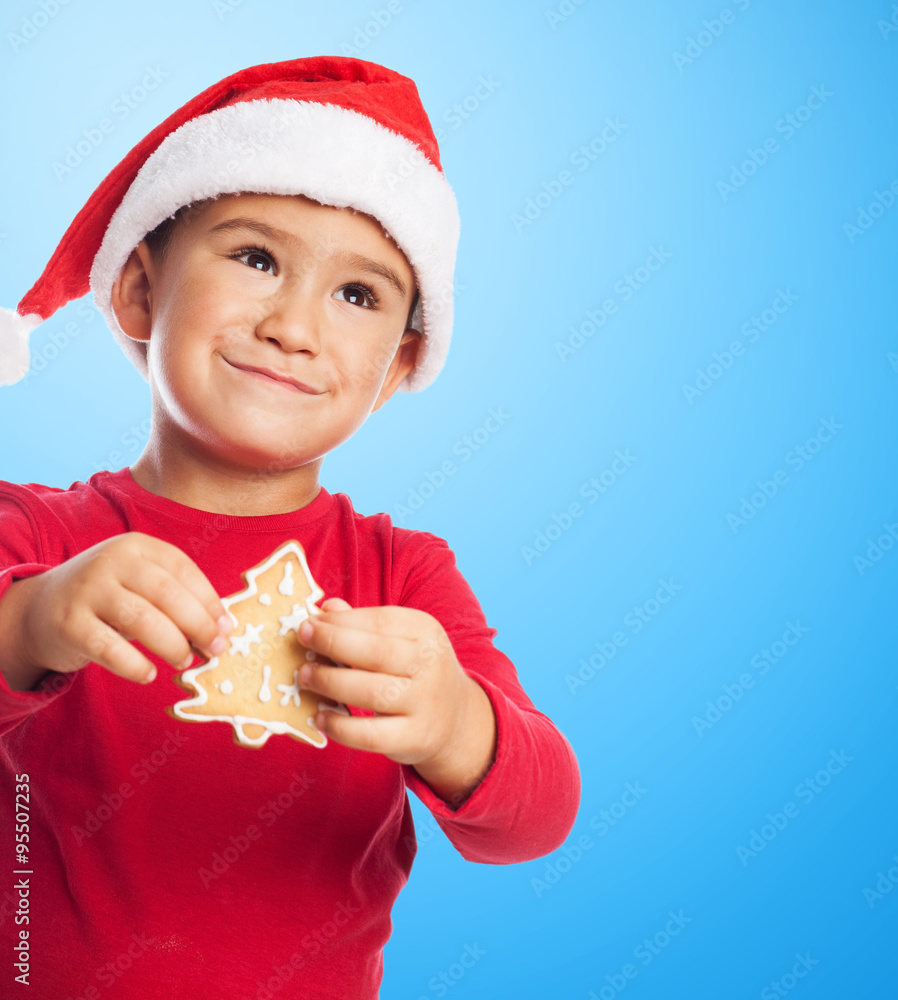 portrait of a little boy holding a christmas cookie portrait of a little boy holding a christmas cookie