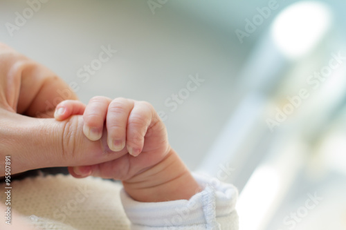 Fotótapéta Newborn baby touching his mother hand