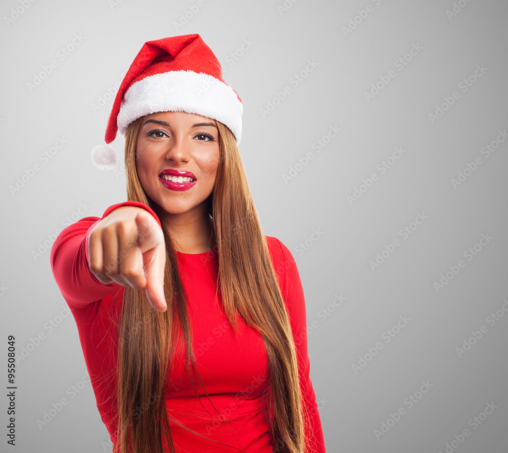 portrait of a beautiful young woman pointing at Christmas portrait of a beautiful young woman pointing at Christmas