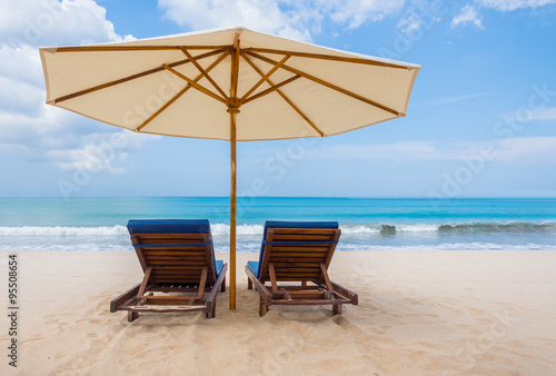 Beach chairs with umbrella and beach on a sunny day © Netfalls