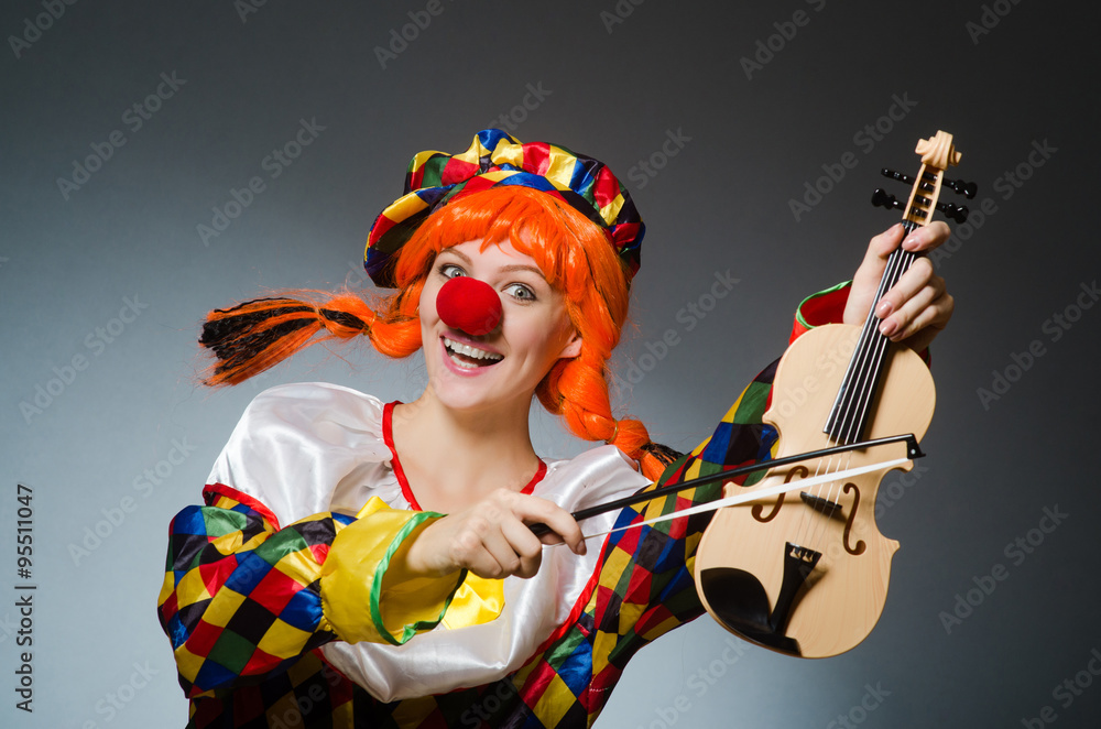 Clown in funny concept on dark background Clown in funny concept on dark background