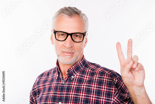 Gray aged man with glasses gesturing two fingers