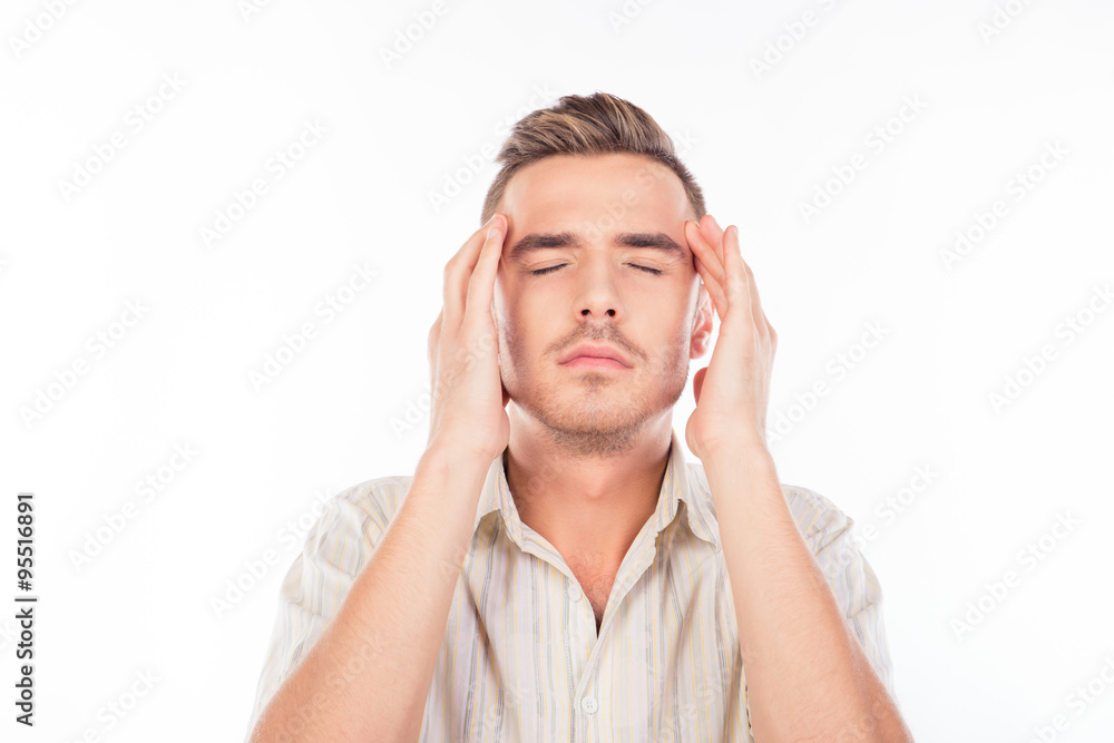 Handsome young man touching his head suffering from headache Handsome young man touching his head suffering from headache