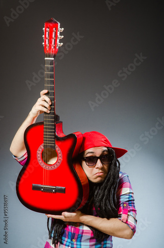 Funny man playing guitar in musical concept