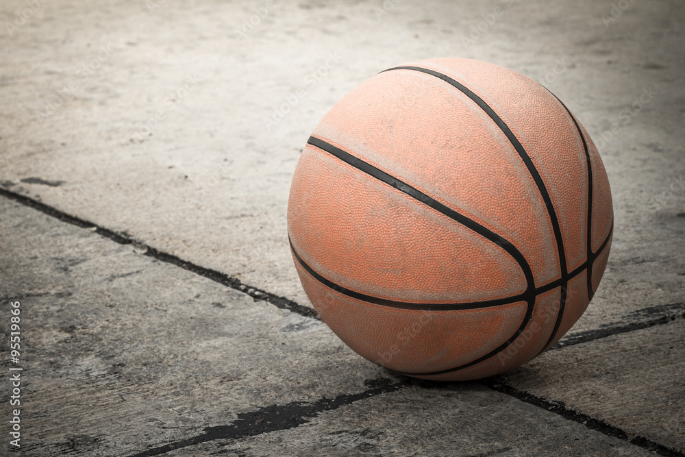 Old basketball on street background