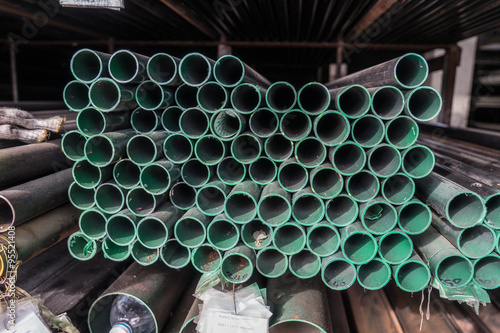 A series of different sizes steel pipes on shelf