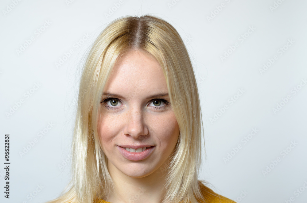 Naklejka premium Face of a Young Woman Against Gray Background
