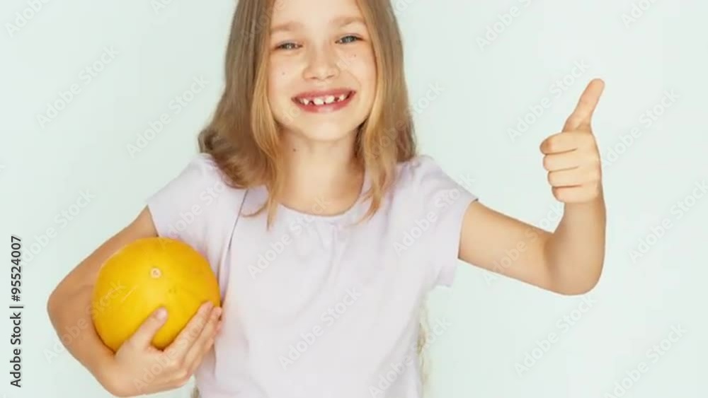 Girl holding melon and playing with berry. Thumb up. Ok. Closeup Girl holding melon and playing with berry. Thumb up. Ok. Closeup