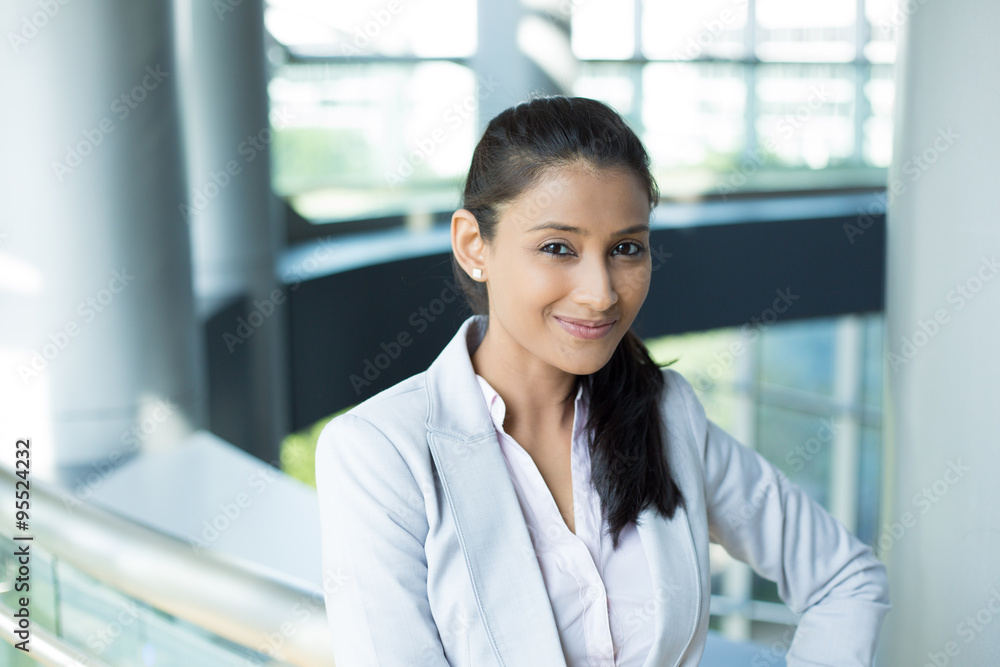 Closeup portrait, charming upbeat smiling joyful happy young woman smirking, thinking daydreaming something nice, isolated indoors office background. Positive human facial expressions feelings Closeup portrait, charming upbeat smiling joyful happy young woman smirking, thinking daydreaming something nice, isolated indoors office background. Positive human facial expressions feelings