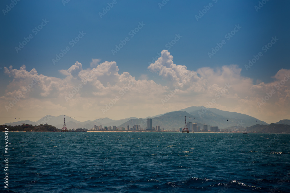 view of hilly islands azure sea against blue sky cumulus clouds