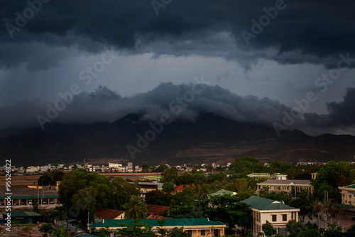 upper view of city dark thunderclouds above city mountains