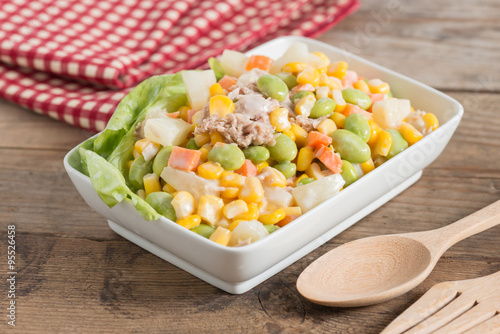 Tuna corn salad in white bowl.