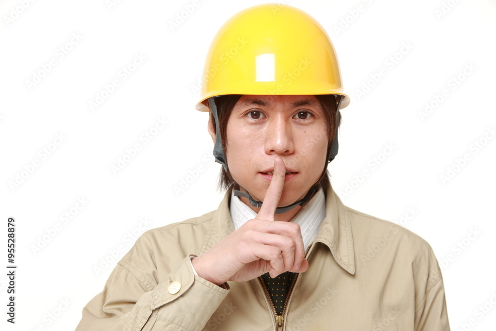 young Japanese construction worker whith silence gestures young Japanese construction worker whith silence gestures