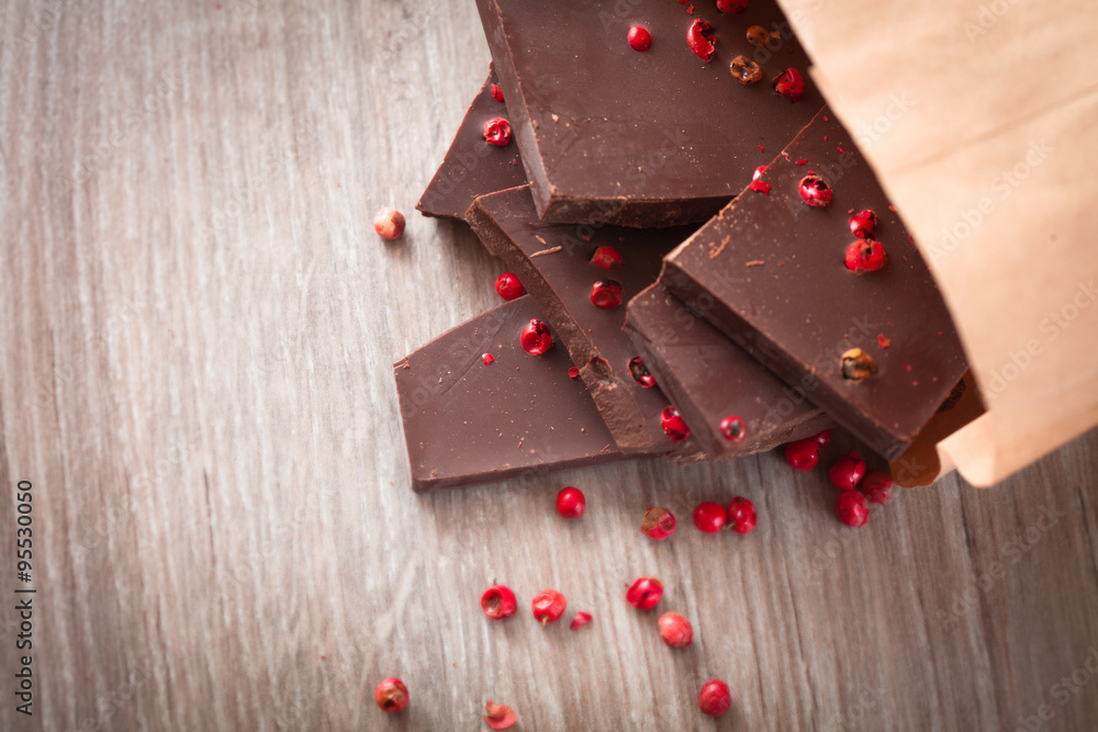 Pieces of dark chocolate with pink pepper Pieces of dark chocolate with pink pepper