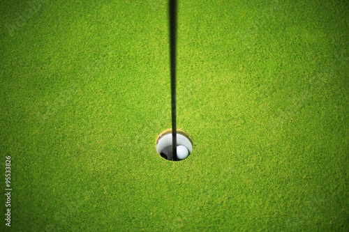 Golf ball at the hole