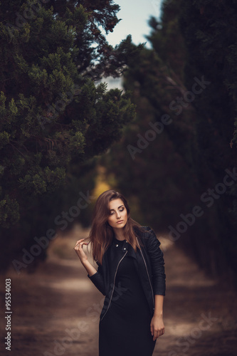 Beautiful young smiling brunette woman with flowers in autumn park © selenit