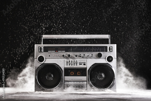 1980s Silver Retro ghetto blaster and dust isolated on black wit
