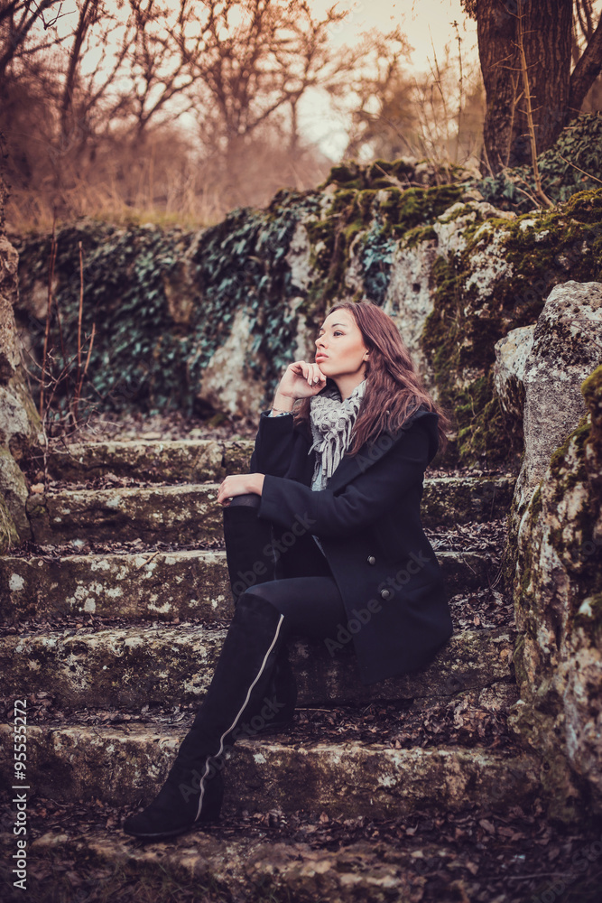 Fashion woman walking in dark autumn park Fashion woman walking in dark autumn park