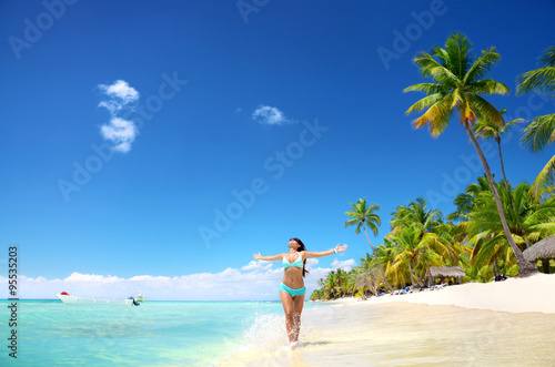 Carefree young woman relaxing on tropical beach