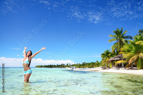 Carefree young woman relaxing on tropical island beach and caribbean sea shore. Dominican Republic