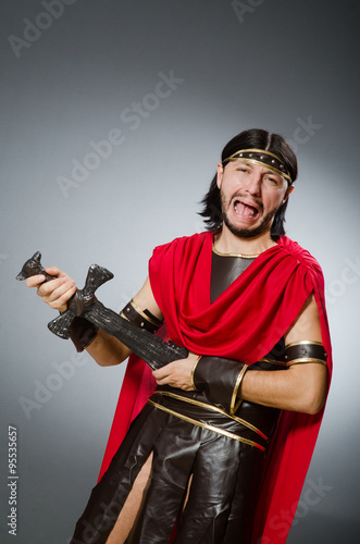 Fototapeta Naklejka Na Ścianę i Meble -  Roman warrior with sword against background