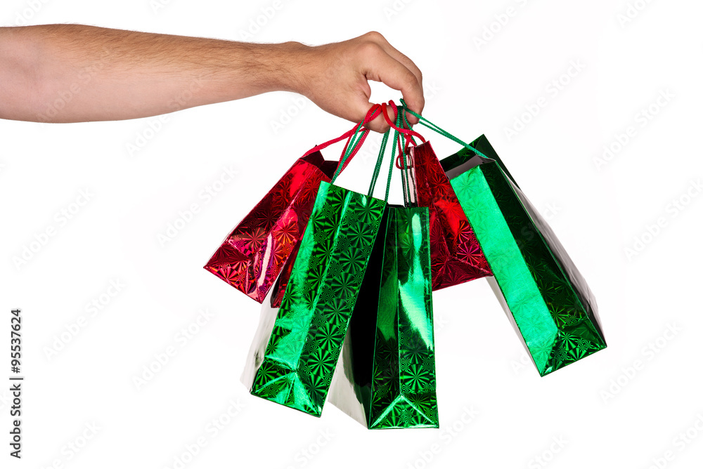 A man hand carrying a bunch of colorful shopping bags