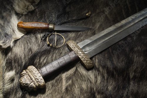 Photography Viking sword and knife on a fur