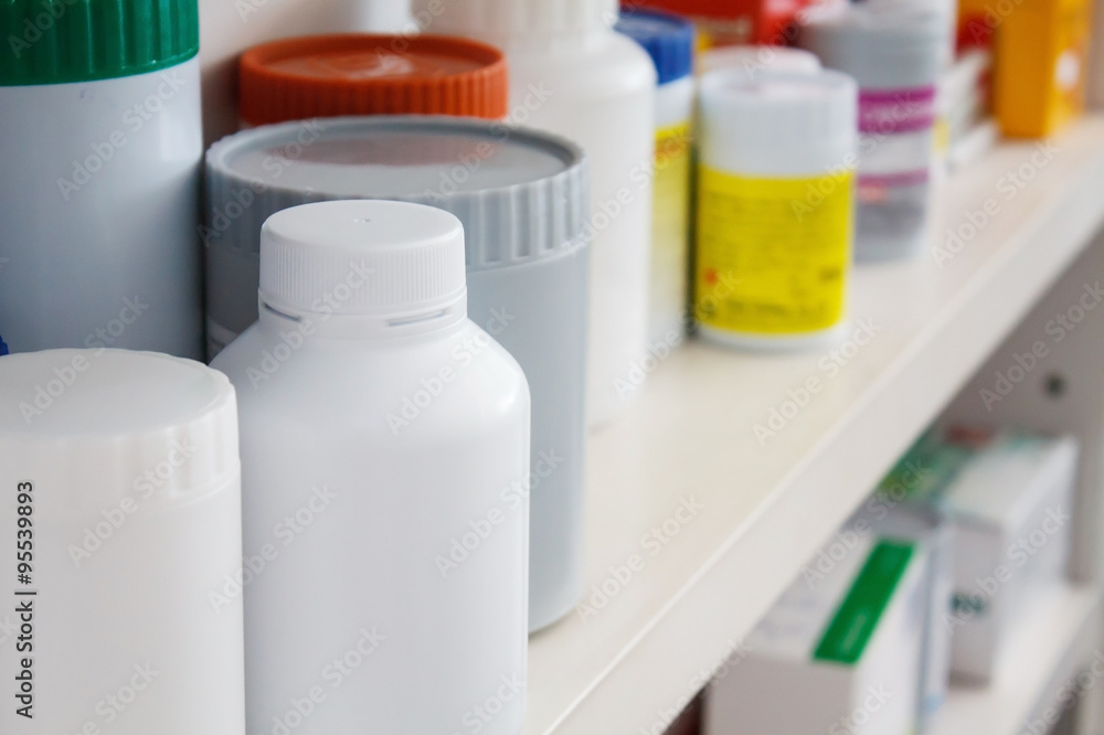 Bottles of pills arranged on shelf at drugstore Bottles of pills arranged on shelf at drugstore