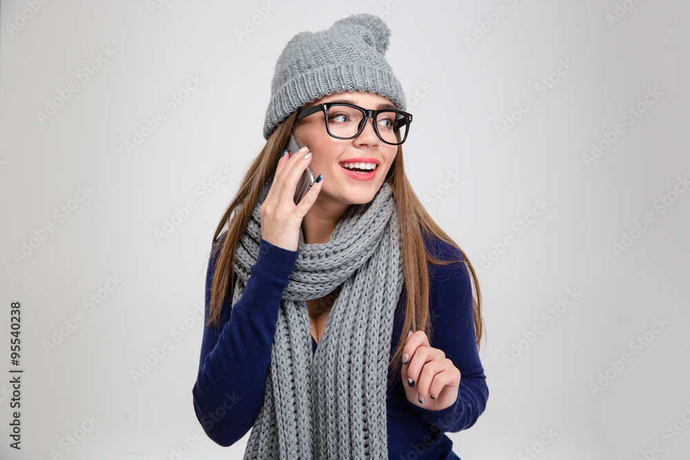 Smiling woman talking on the phone and looking away Smiling woman talking on the phone and looking away