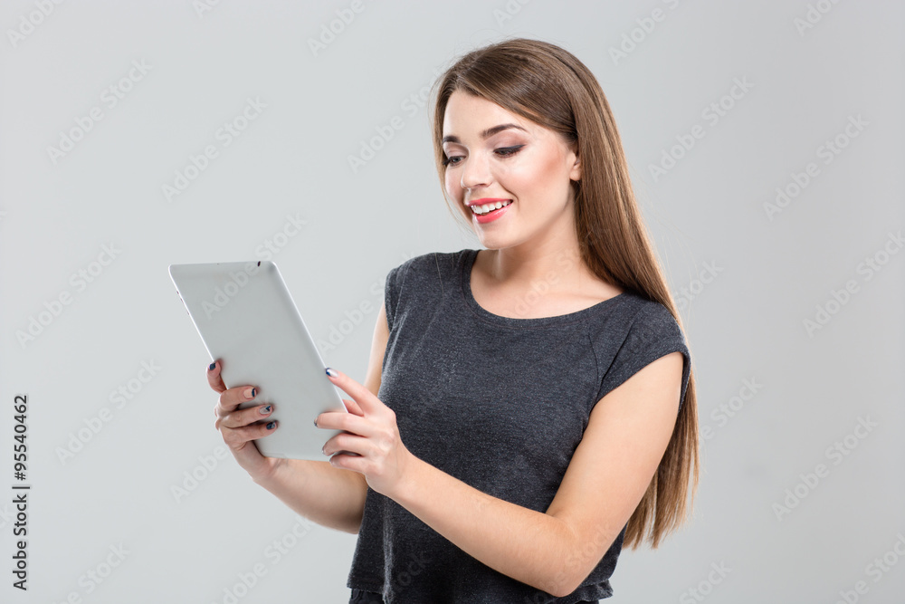 Smiling woman using tablet computer Smiling woman using tablet computer
