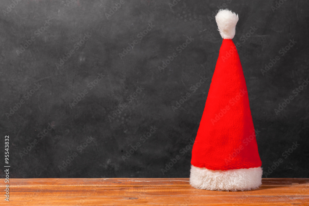 The Santa red hat on wooden background The Santa red hat on wooden background