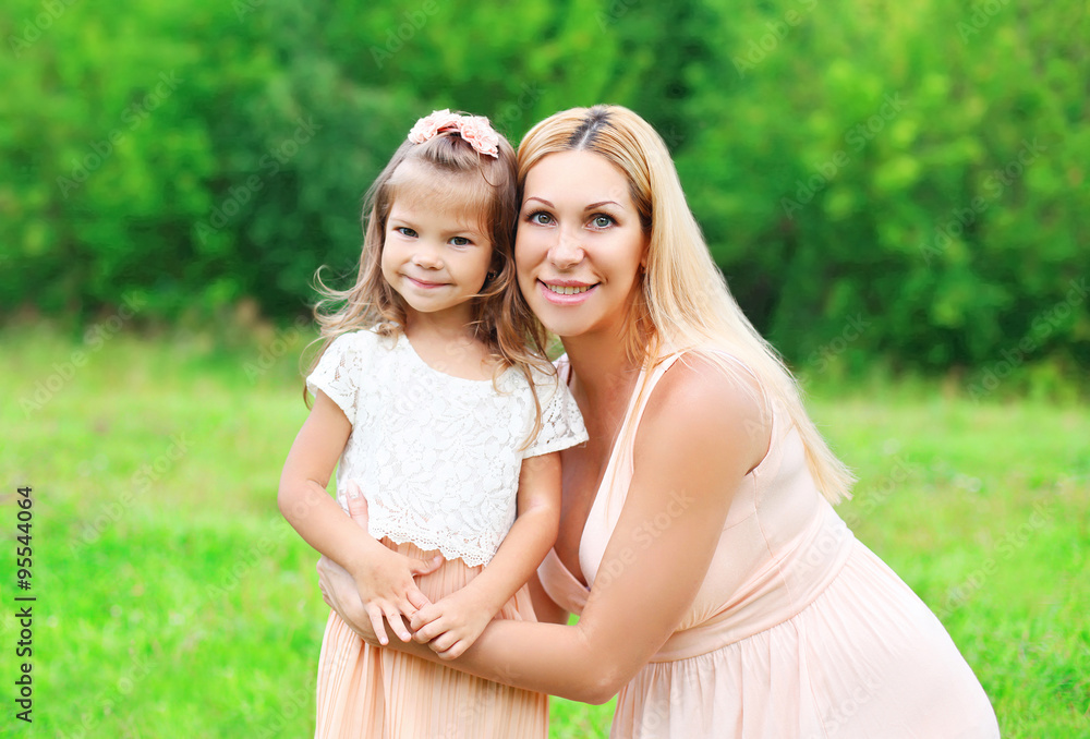 Fototapeta premium Portrait happy mother and daughter child together in summer day
