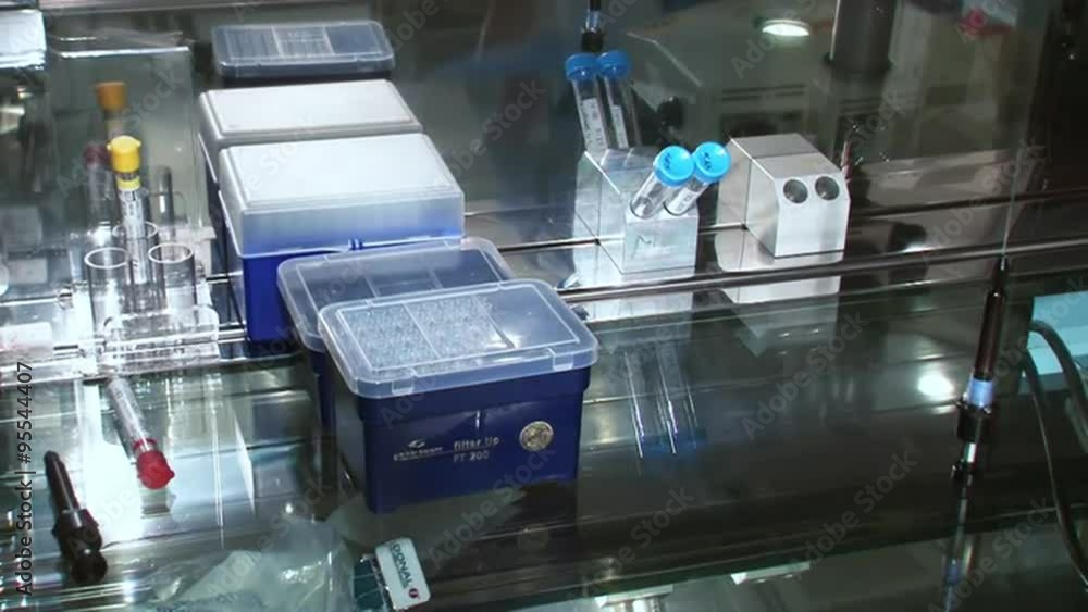 Fertility doctor with a microscope, a syringe and petri dish fertilization of eggs and research in reproduction clinics. Storing frozen eggs and sperm in a box filled with liquid nitrogen. Fertility doctor with a microscope, a syringe and petri dish fertilization of eggs and research in reproduction clinics. Storing frozen eggs and sperm in a box filled with liquid nitrogen.
