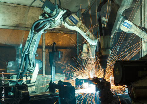 Team robot welding steel motion blur industry.