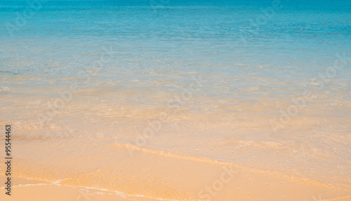 Bright orange sand and blue sea