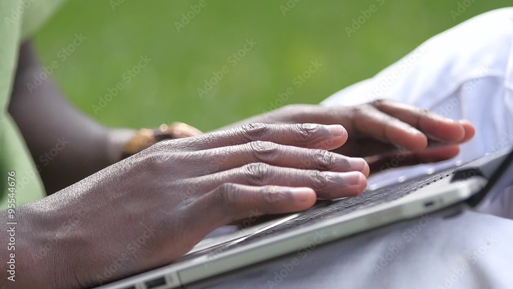 Man Working in Park. a young black guy is sitting. slow motion, close up Man Working in Park. a young black guy is sitting. slow motion, close up