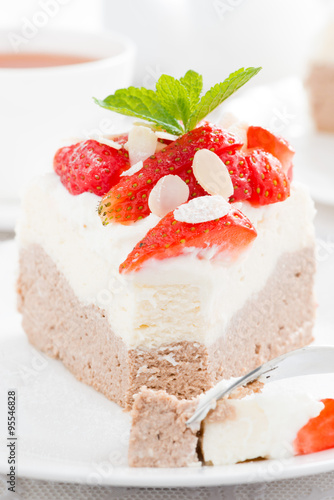 piece of delicious cake with whipped cream and strawberries