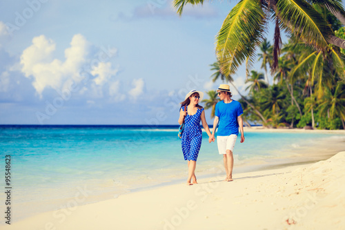 happy loving couple walking on summer beach © nadezhda1906
