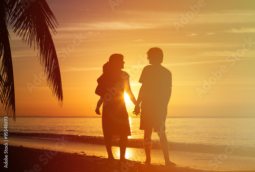 young couple with little child at sunset tropical beach © nadezhda1906