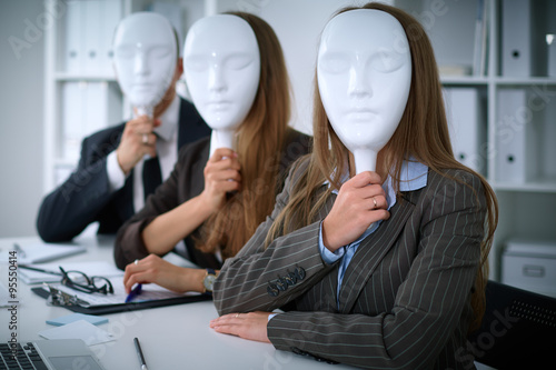 Group of business people  at meeting. Business people hide their emotions under the mask of confidence during the negotiations , business concept photo