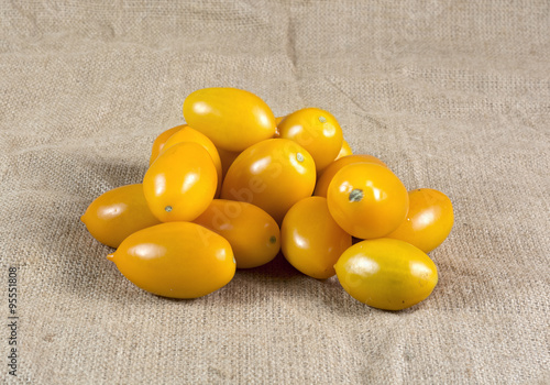 Ripe yellow tomatoes on a burlap canvas photo