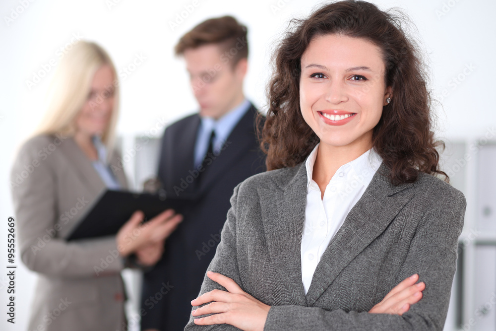 Face of beautiful cheerful smiling business woman on the background of business people Successful business concept Face of beautiful cheerful smiling business woman on the background of business people Successful business concept