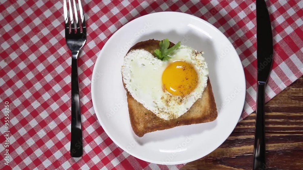 Heart-shaped fried eggs for breakfast. dolly shot Heart-shaped fried eggs for breakfast. dolly shot