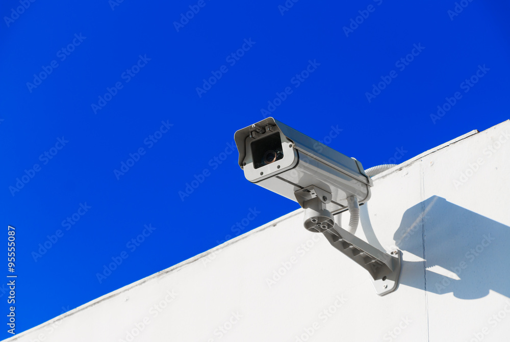 CCTV on building with blue-sky background CCTV on building with blue-sky background